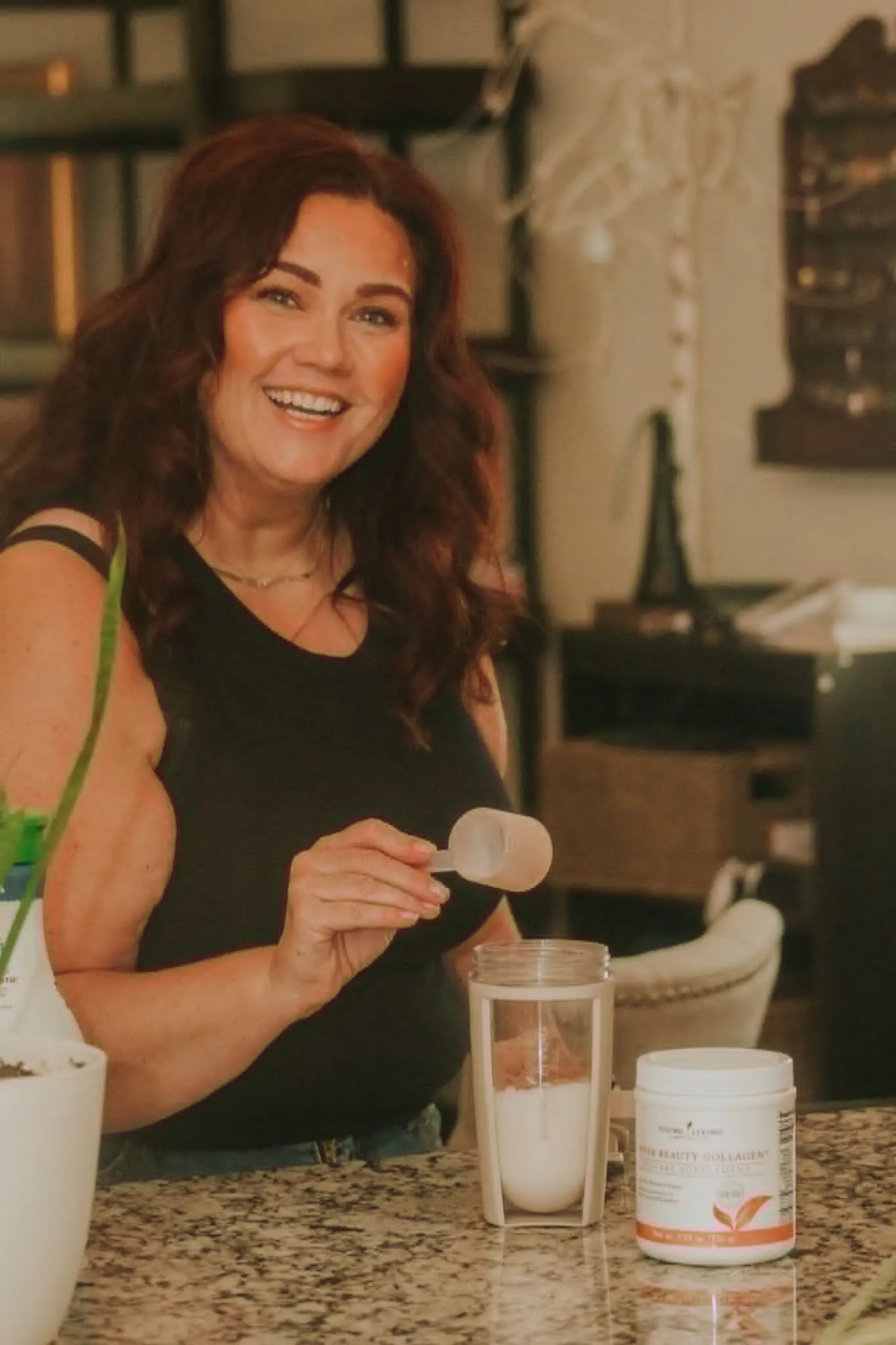 Melissa Anne measuring collagen supplements in her kitchen